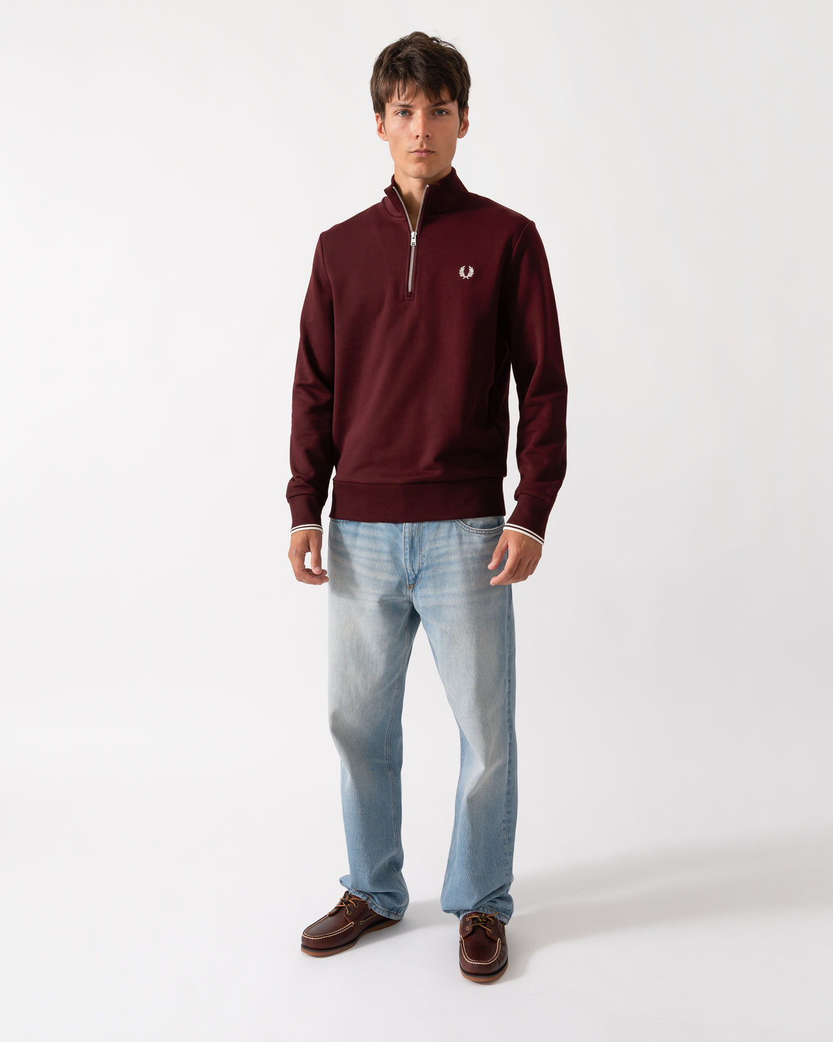 full length shot of a model wearing a Fred Perry Mens Half Zip Sweatshirt Oxblood/Ecru 64A