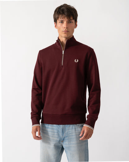 model wearing a Fred Perry Mens Half Zip Sweatshirt Oxblood/Ecru 64A