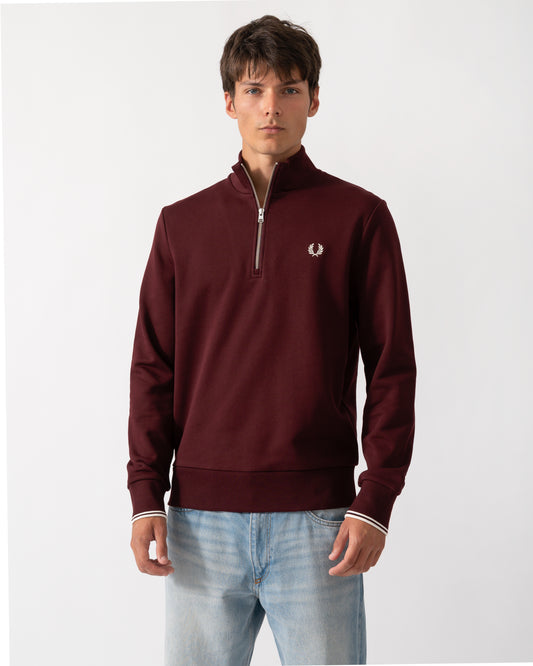 model wearing a Fred Perry Mens Half Zip Sweatshirt Oxblood/Ecru 64A