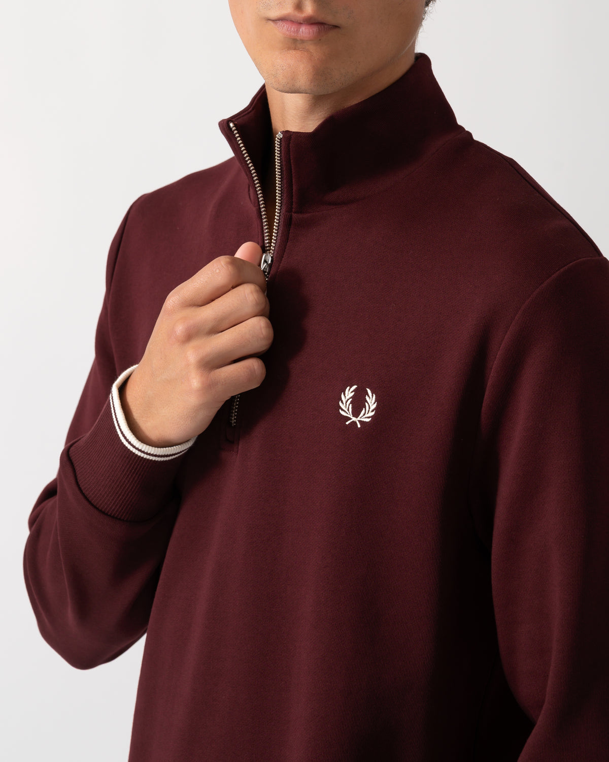 close up of a model wearing a Fred Perry Mens Half Zip Sweatshirt Oxblood/Ecru 64A