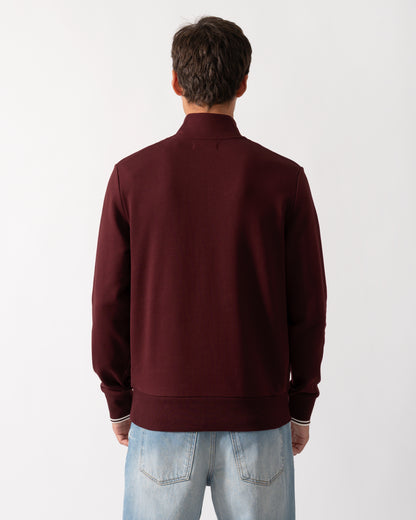 back of a model wearing a Fred Perry Mens Half Zip Sweatshirt Oxblood/Ecru 64A