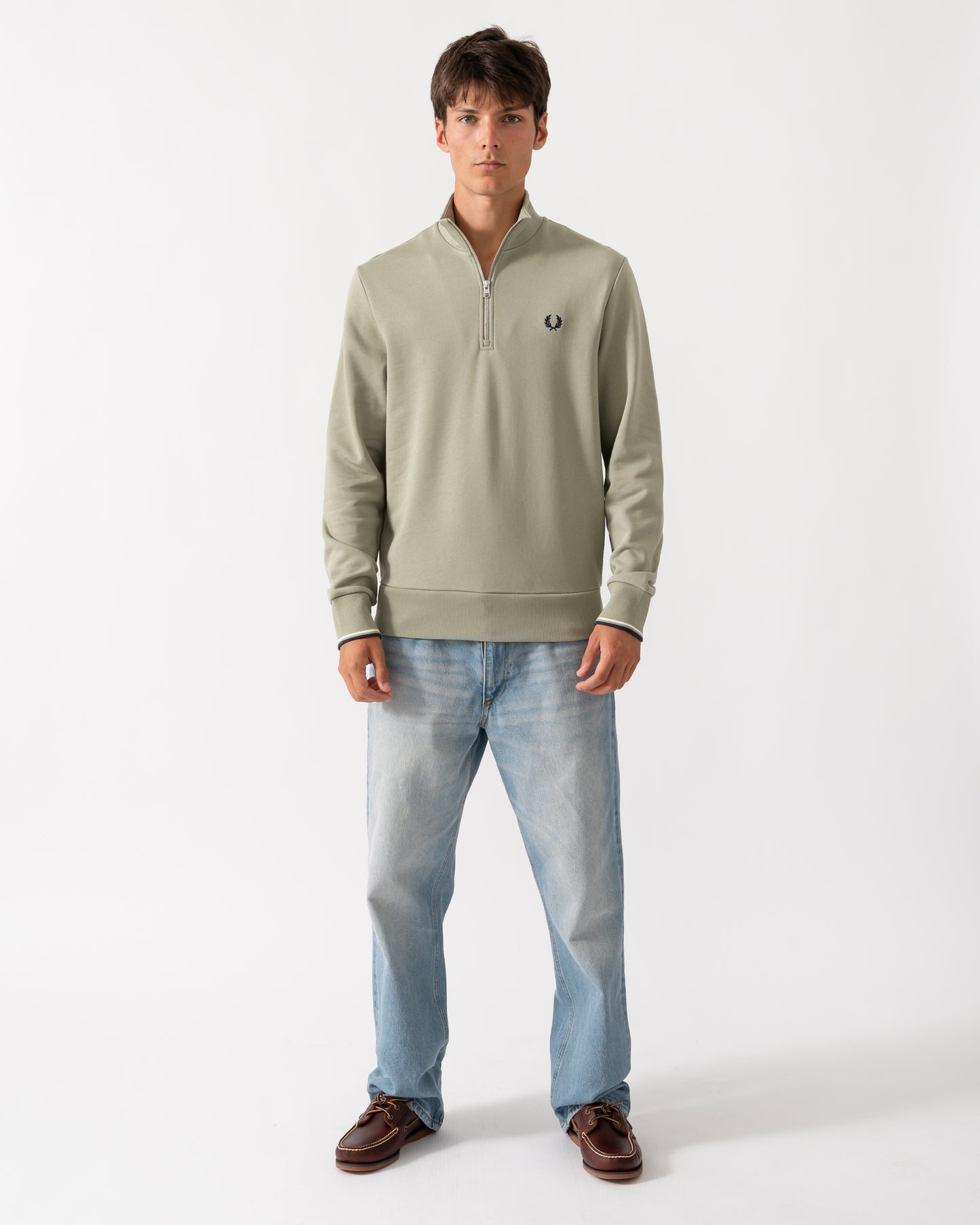 full length of a model wearing a Fred Perry Mens Half Zip Sweatshirt in Seagrass with Ecru and Dark Airforce trim
