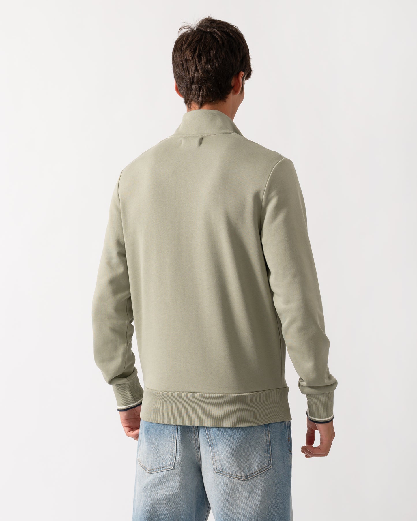 back of a model wearing a Fred Perry Mens Half Zip Sweatshirt in Seagrass with Ecru and Dark Airforce trim