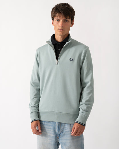 model wearng a Fred Perry Mens Half Zip Sweatshirt in Silver Blue/Dark Airforce 71C