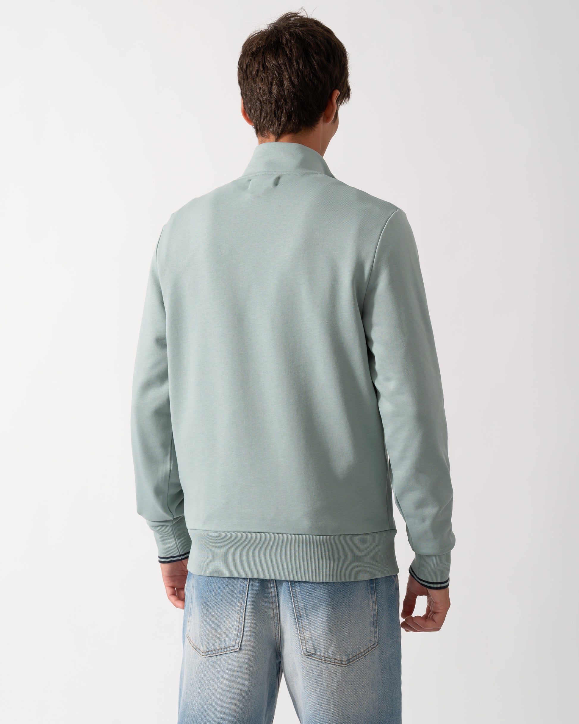 back of a model wearng a Fred Perry Mens Half Zip Sweatshirt in Silver Blue/Dark Airforce 71C