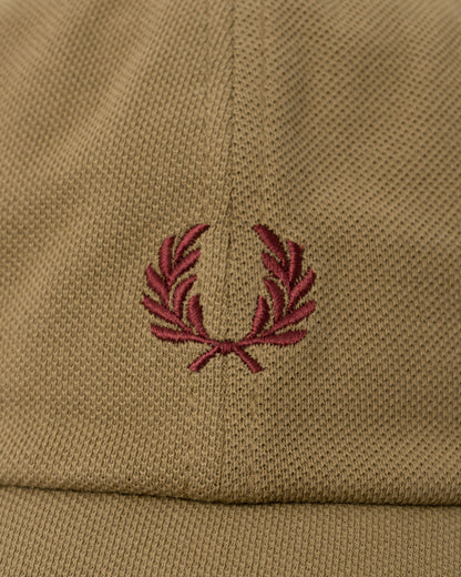 Close up of the Fred Perry Mens Pique Classic Cap - Bronze/Oxblood 62D