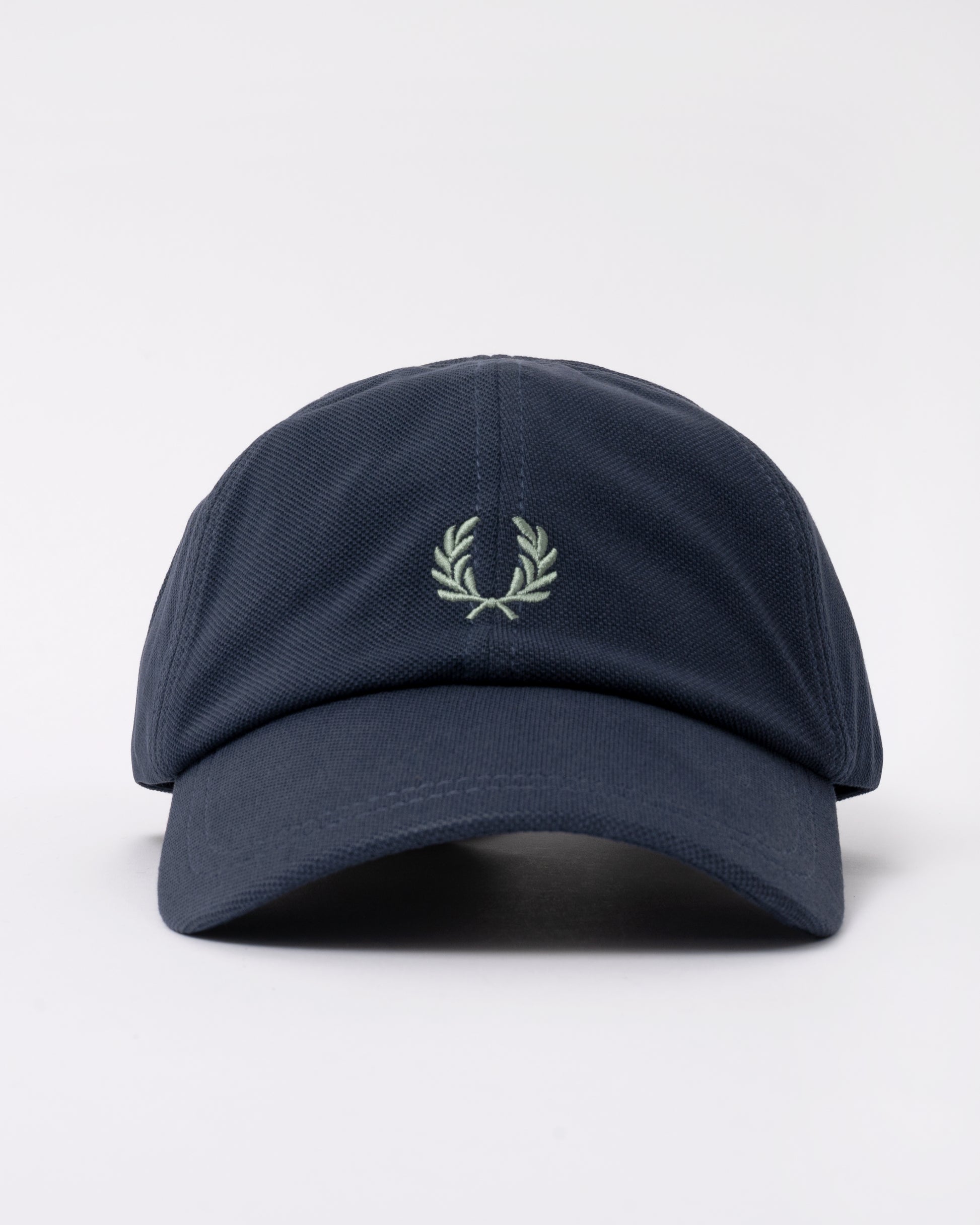 front of a Fred Perry Mens Pique Classic Cap in Dark Airforce and Seagrass 90C