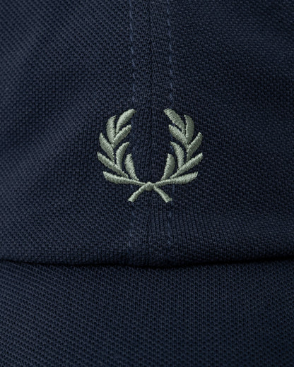 logo detail of a Fred Perry Mens Pique Classic Cap in Dark Airforce and Seagrass 90C