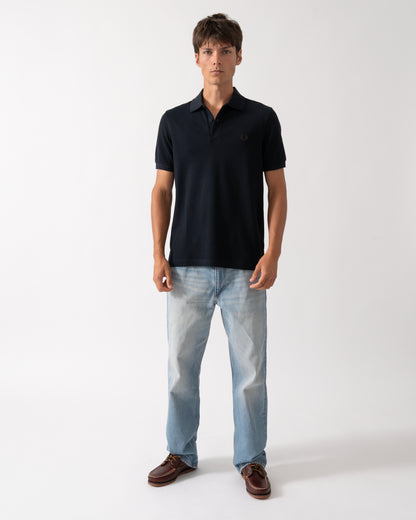 full length of a model wearing a Fred Perry Mens Plain Signature Polo Shirt in Navy with Rich Brown trim