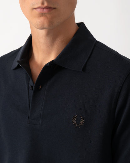 close up model wearing a Fred Perry Mens Plain Signature Polo Shirt in Navy with Rich Brown trim