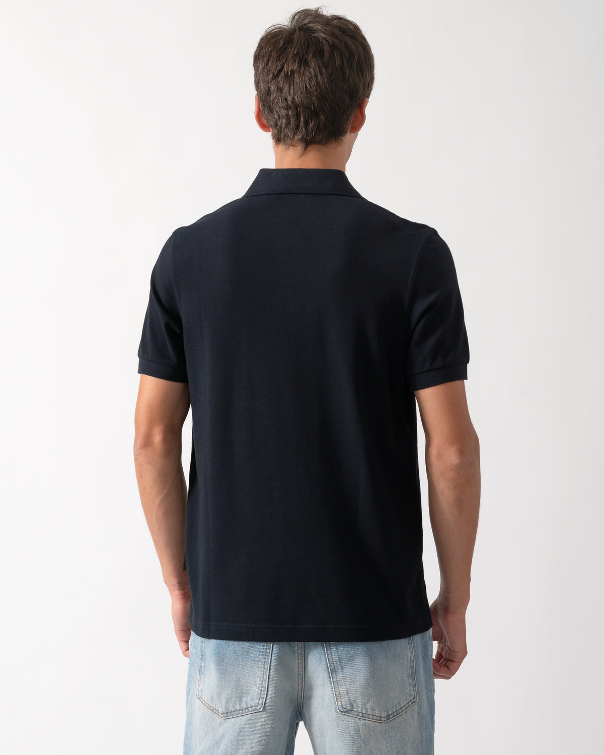back of a model wearing a Fred Perry Mens Plain Signature Polo Shirt in Navy with Rich Brown trim