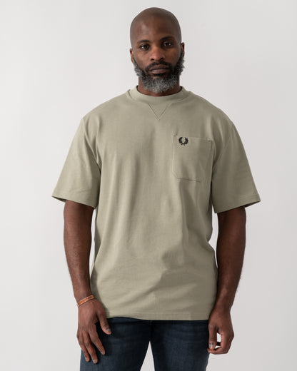 Model wearing a Fred Perry Mens Pocket Detail T-Shirt in Seagrass