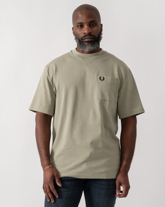 Model wearing a Fred Perry Mens Pocket Detail T-Shirt in Seagrass