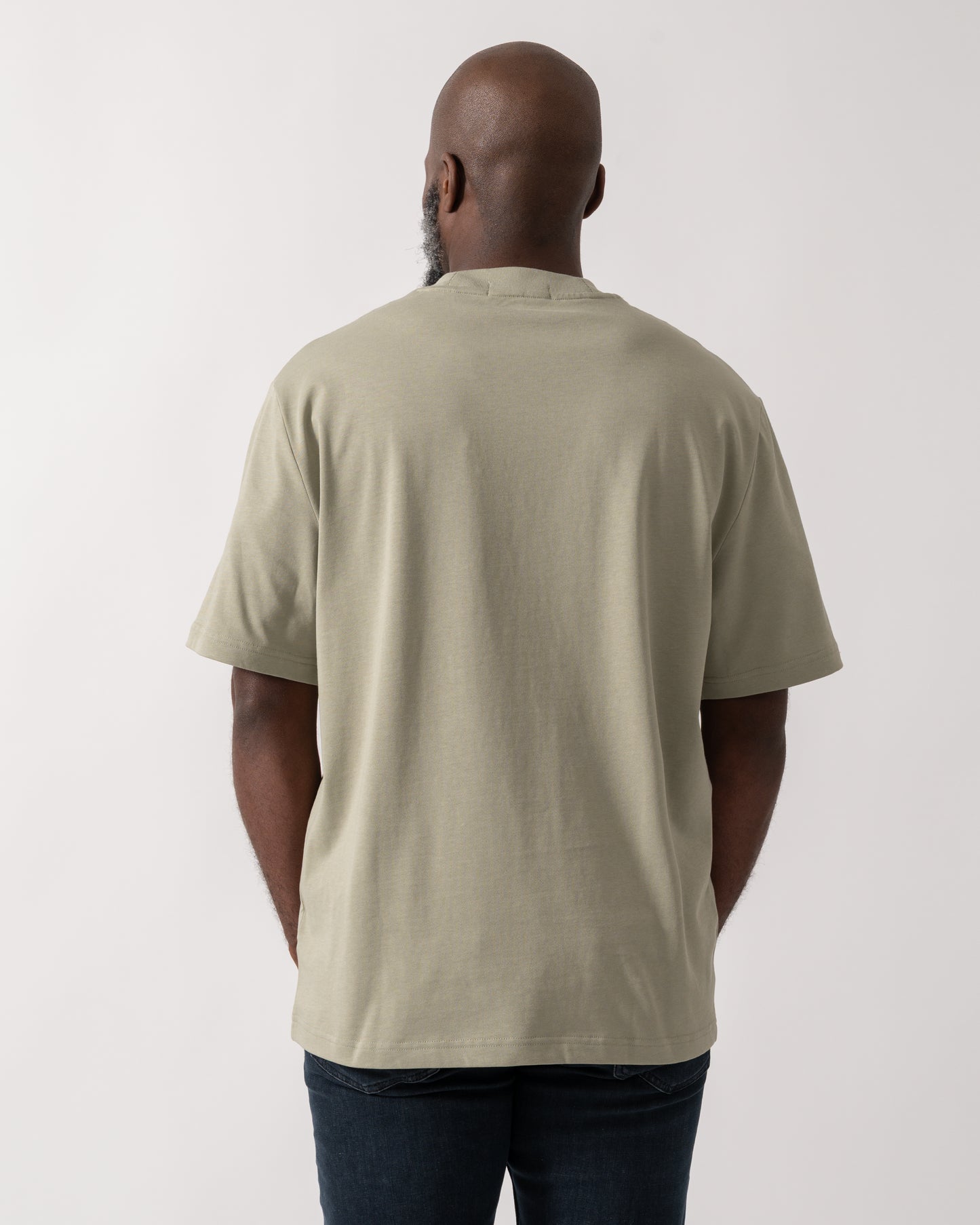 back shot of a Model wearing a Fred Perry Mens Pocket Detail T-Shirt in Seagrass