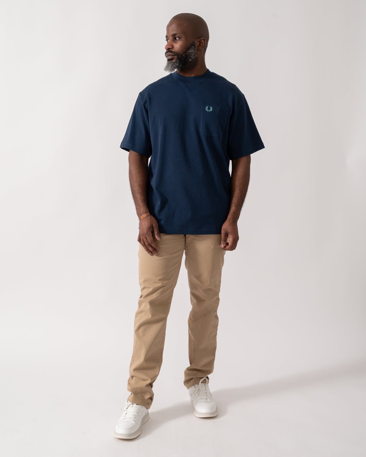 Full length shot of a Model wearing a Fred Perry Mens Pocket Detail T-Shirt in Tennis Blue