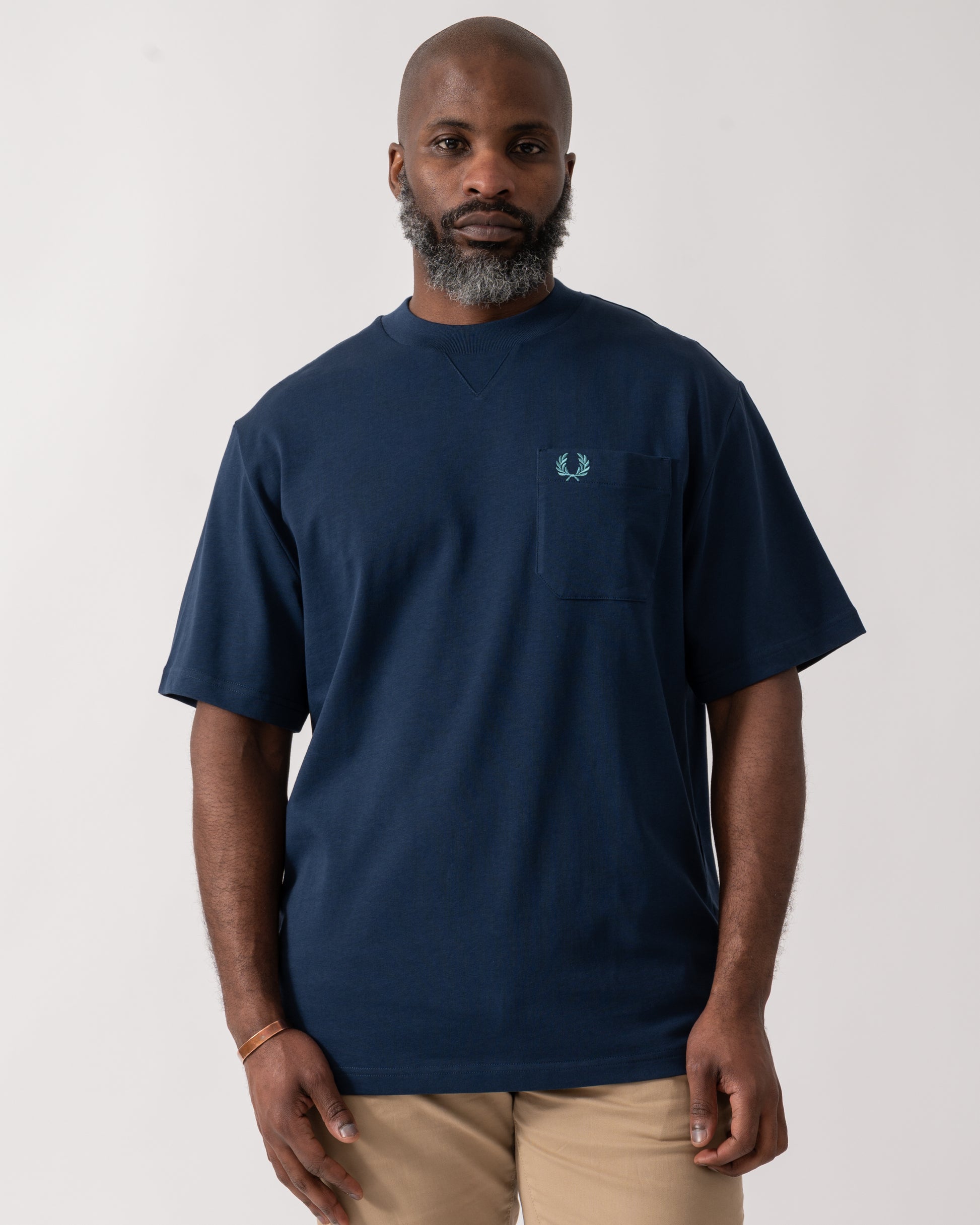 Model wearing a Fred Perry Mens Pocket Detail T-Shirt in Tennis Blue