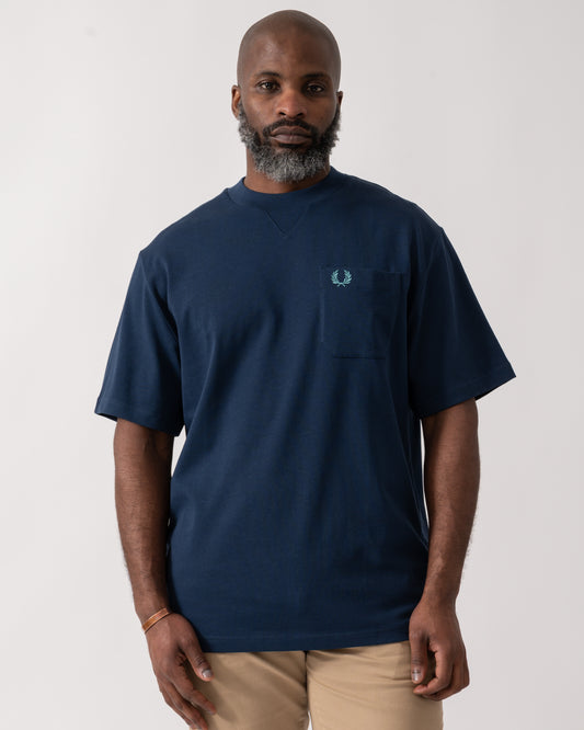 Model wearing a Fred Perry Mens Pocket Detail T-Shirt in Tennis Blue
