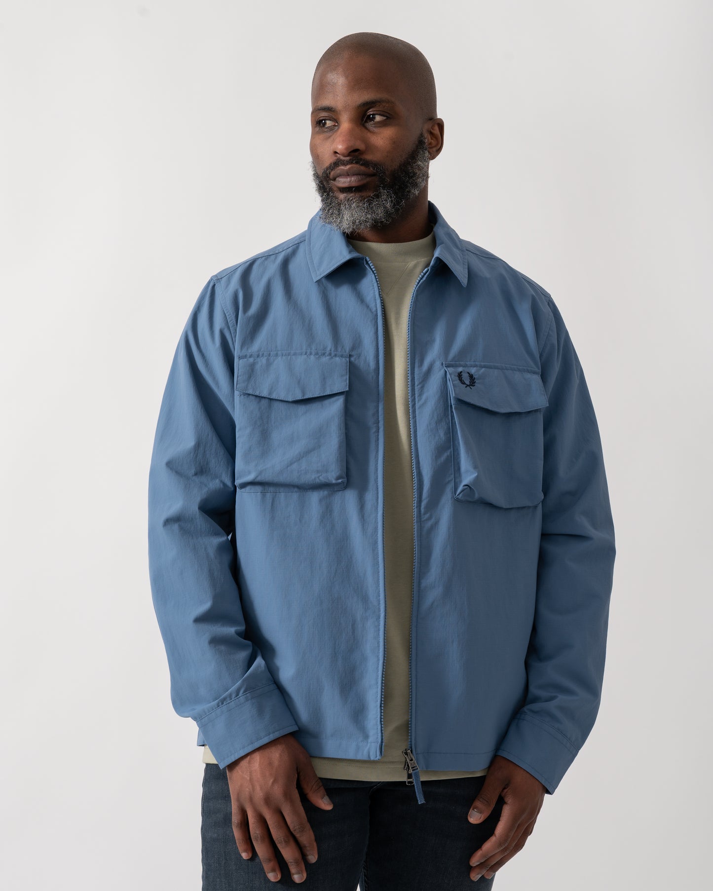 Model wearing a Fred Perry Mens Ripstop Pocket Overshirt in Ace Blue