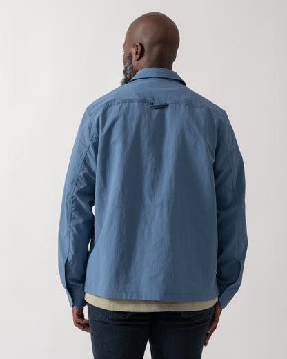 back shot of a Model wearing a Fred Perry Mens Ripstop Pocket Overshirt in Ace Blue