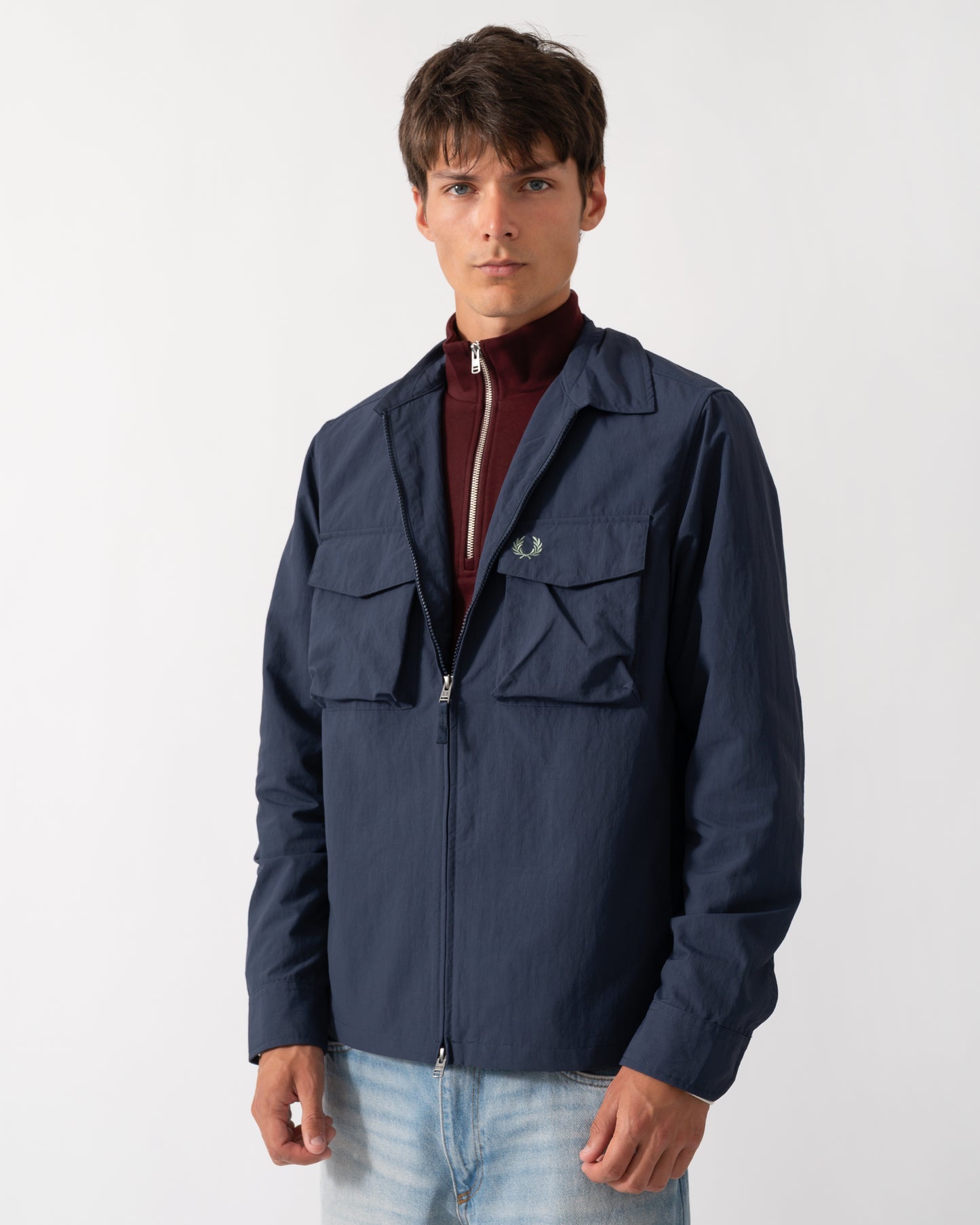 model wearing a Fred Perry Mens Ripstop Pocket Overshirt in Dark Airforce 738
