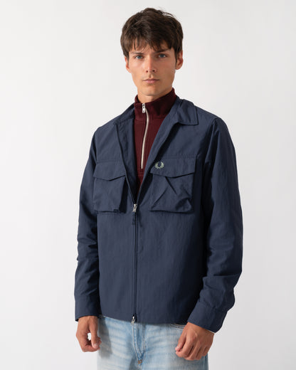 model wearing a Fred Perry Mens Ripstop Pocket Overshirt in Dark Airforce 738