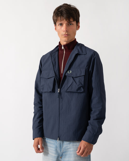 model wearing a Fred Perry Mens Ripstop Pocket Overshirt in Dark Airforce 738
