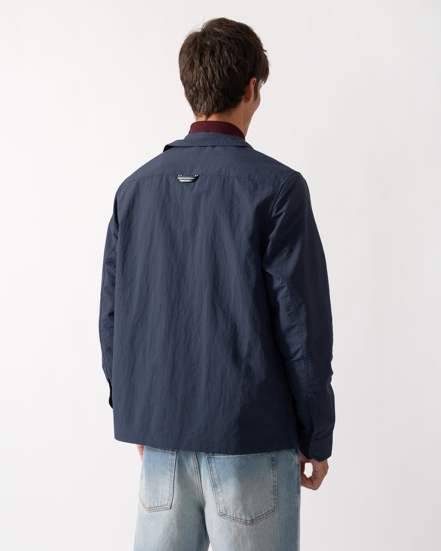 back of a model wearing a Fred Perry Mens Ripstop Pocket Overshirt in Dark Airforce 738