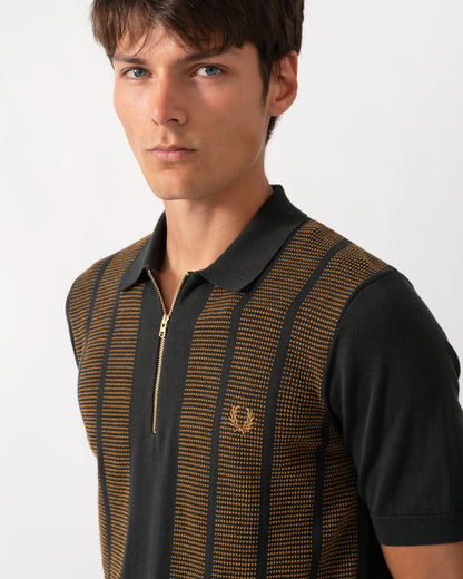 close up of model wearing a Fred Perry Mens Textured Panel Knitted Polo Shirt in Night Green Q20