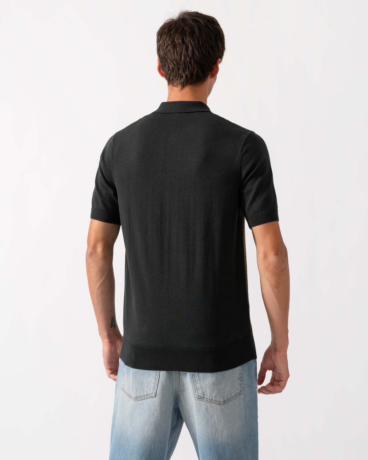 back of model wearing a Fred Perry Mens Textured Panel Knitted Polo Shirt in Night Green Q20