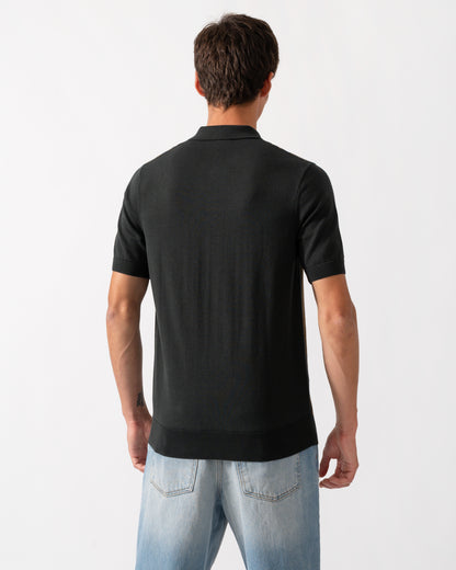 back of model wearing a Fred Perry Mens Textured Panel Knitted Polo Shirt in Night Green Q20
