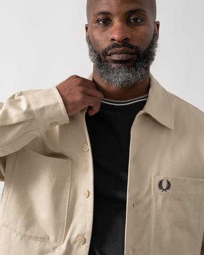 detail shot of a Model wearing a Fred Perry Mens Twill Overshirt in Oatmeal