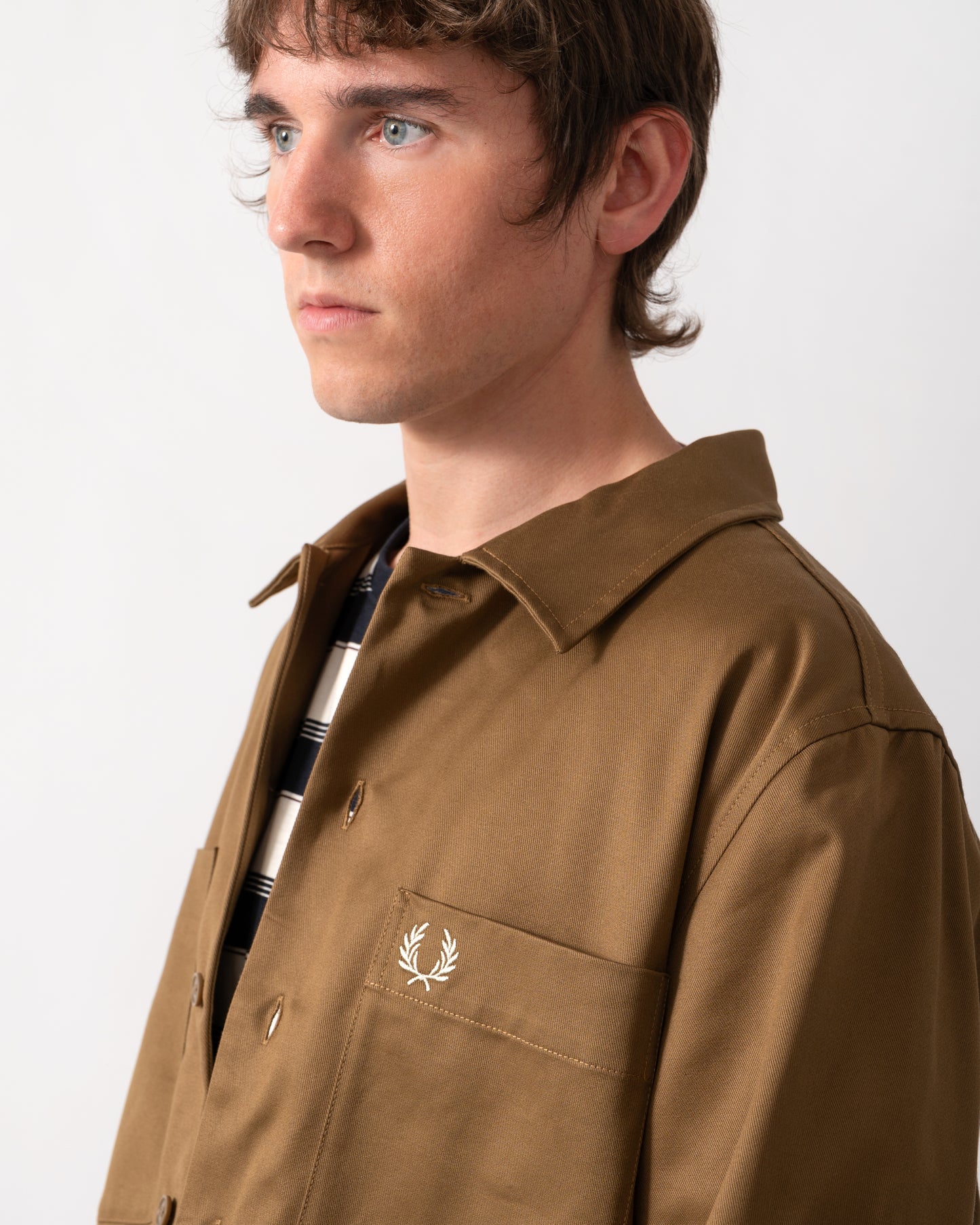 close up of a model wearing a Fred Perry Mens Twill Overshirt in Shaded Stone P96