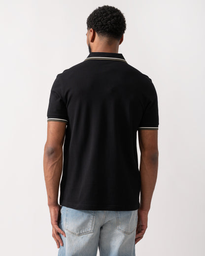 back of a model wearing a Fred Perry Mens Twin Tipped Signature Polo Shirt in Black with Ecru and Laurel Wreath Green trim