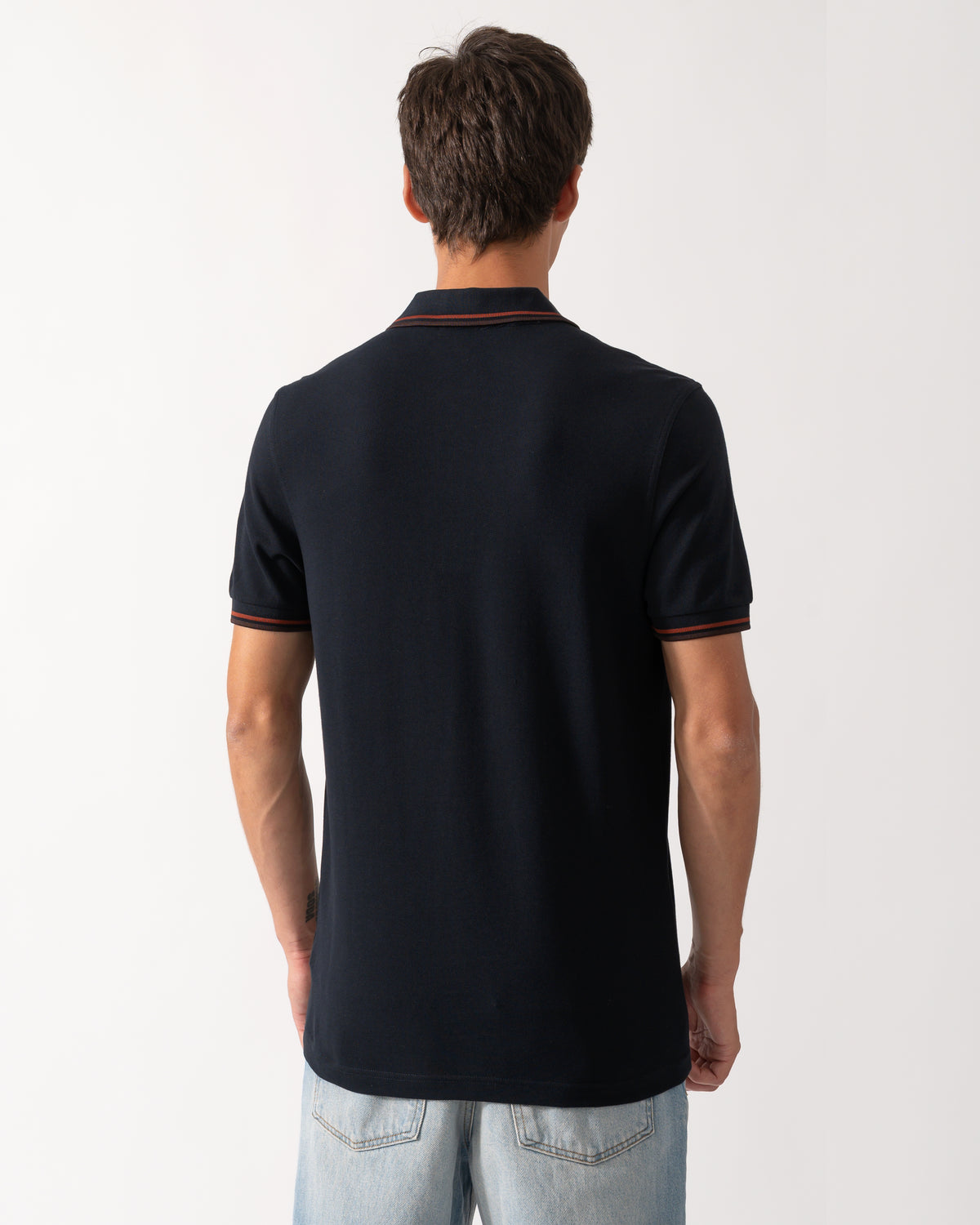 back of a model wearing a Fred Perry Mens Twin Tipped Signature Polo Shirt in Navy with Burgundy and Rich brown trim