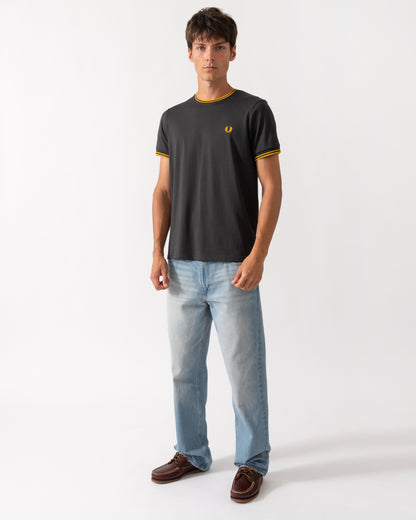 full length of a model wearing a Fred Perry Mens Twin Tipped T-Shirt in Anchor Grey-Golden 85C
