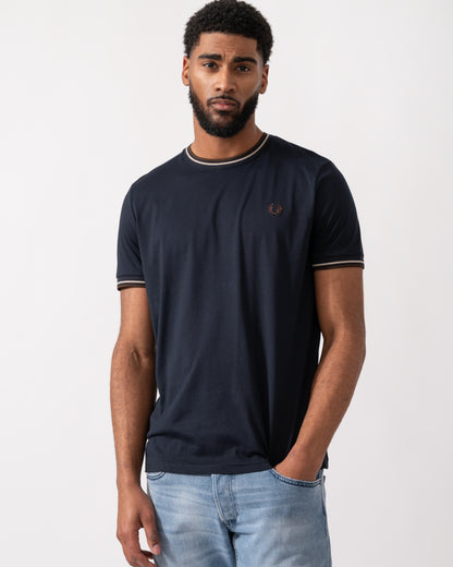 Model wearing a Fred Perry Mens Twin Tipped T-Shirt  in Navy with Warm Oatmeal and Burnt Tobacco trim