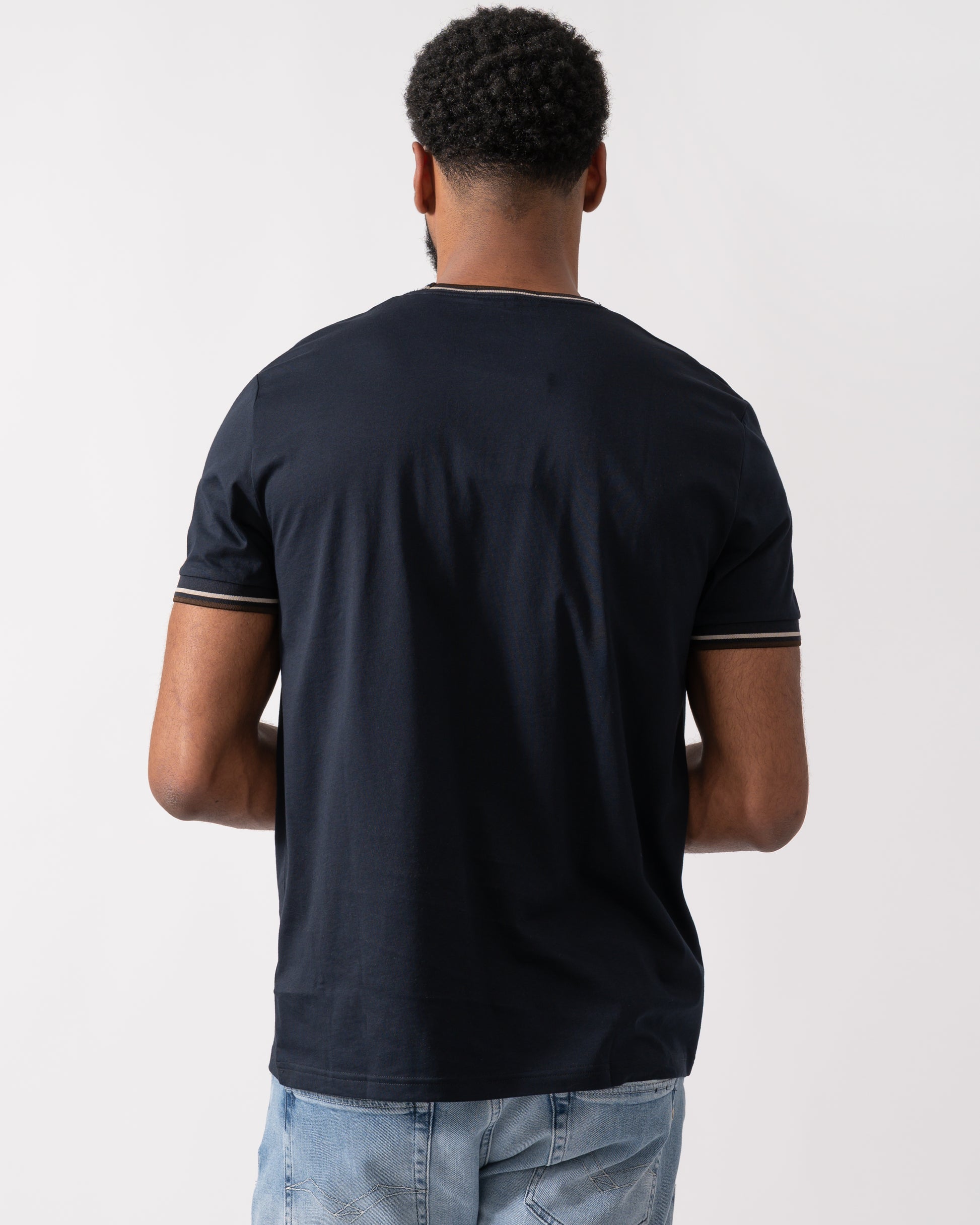 back shot of a Model wearing a Fred Perry Mens Twin Tipped T-Shirt  in Navy with Warm Oatmeal and Burnt Tobacco trim