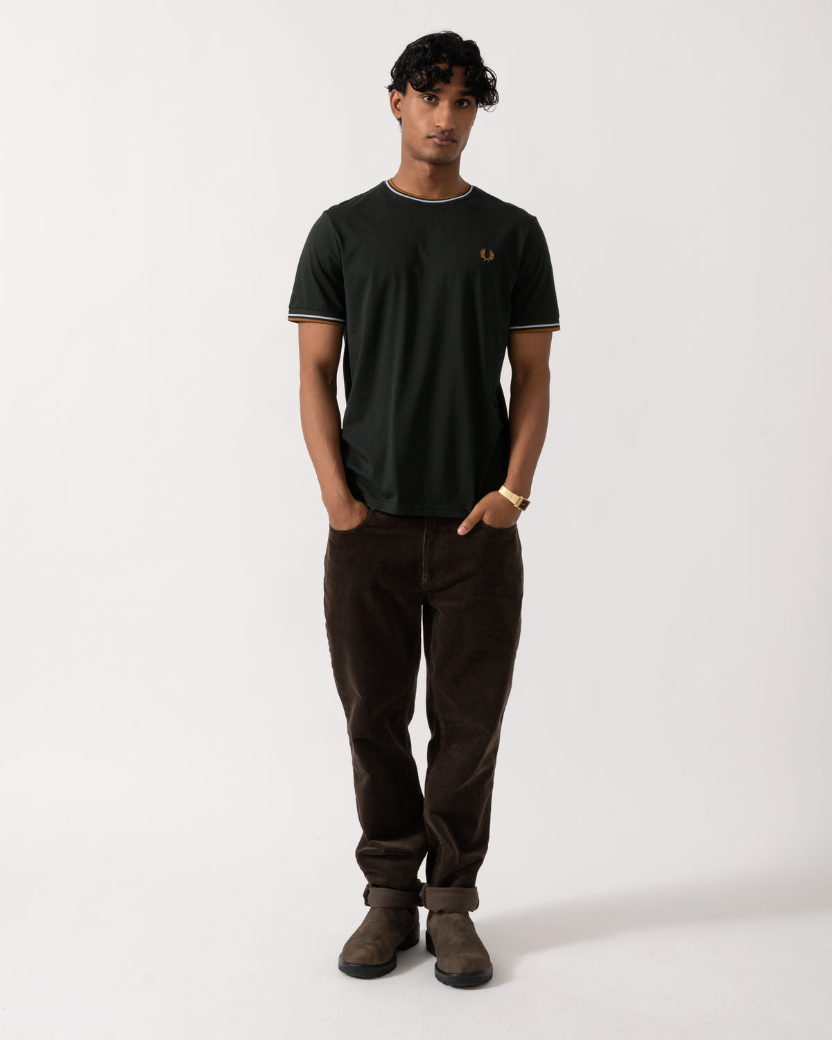 full length studio photograph of a model wearing a Fred Perry Mens Twin Tipped T-Shirt in Night Green with Dusk Blue and Dark Caramel trim 78C