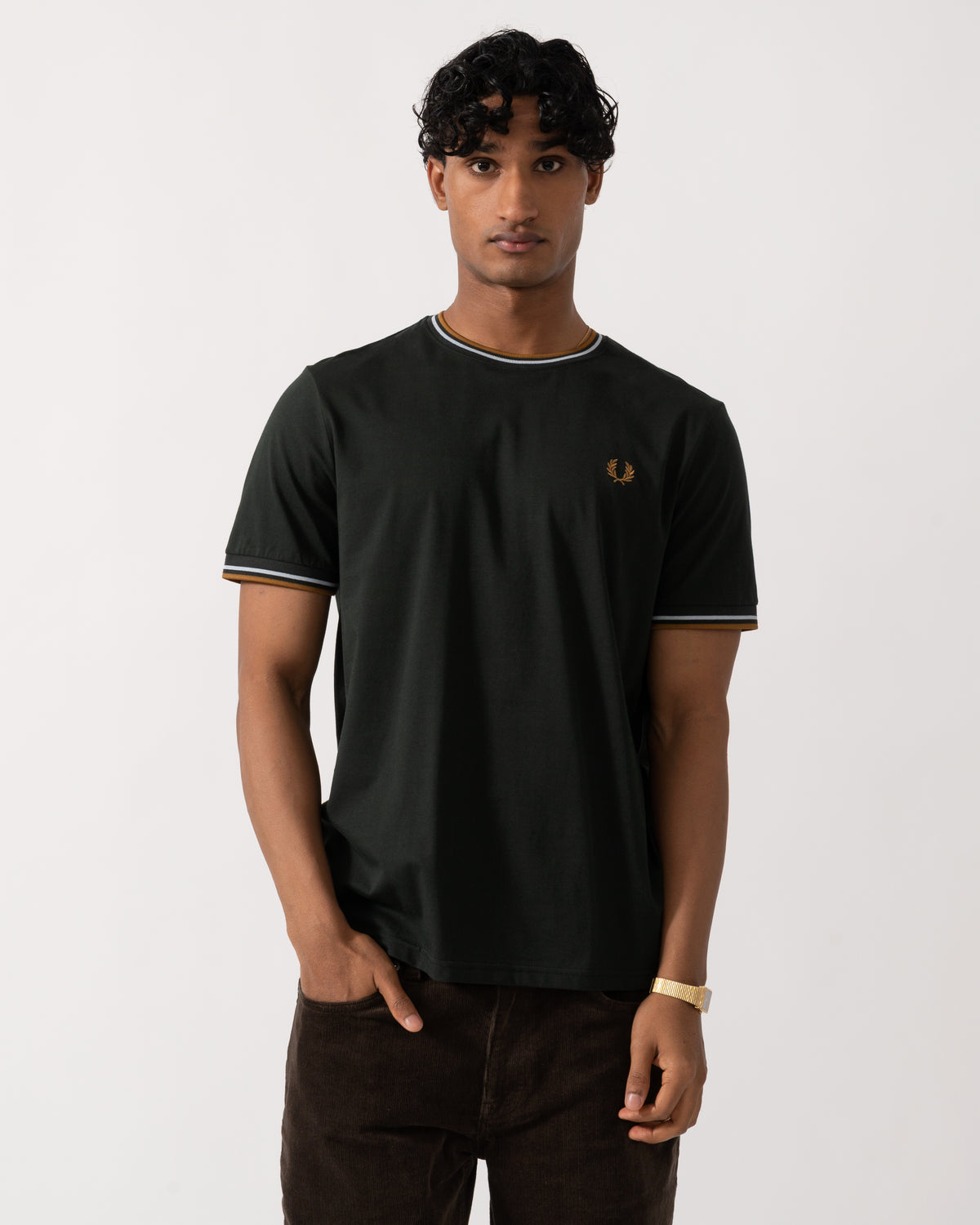 studio photograph of a model wearing a Fred Perry Mens Twin Tipped T-Shirt in Night Green with Dusk Blue and Dark Caramel trim 78C