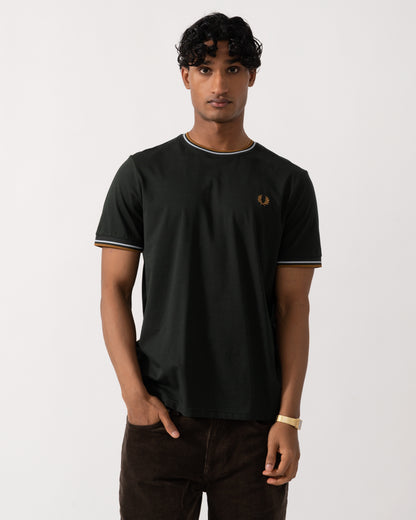 studio photograph of a model wearing a Fred Perry Mens Twin Tipped T-Shirt in Night Green with Dusk Blue and Dark Caramel trim 78C