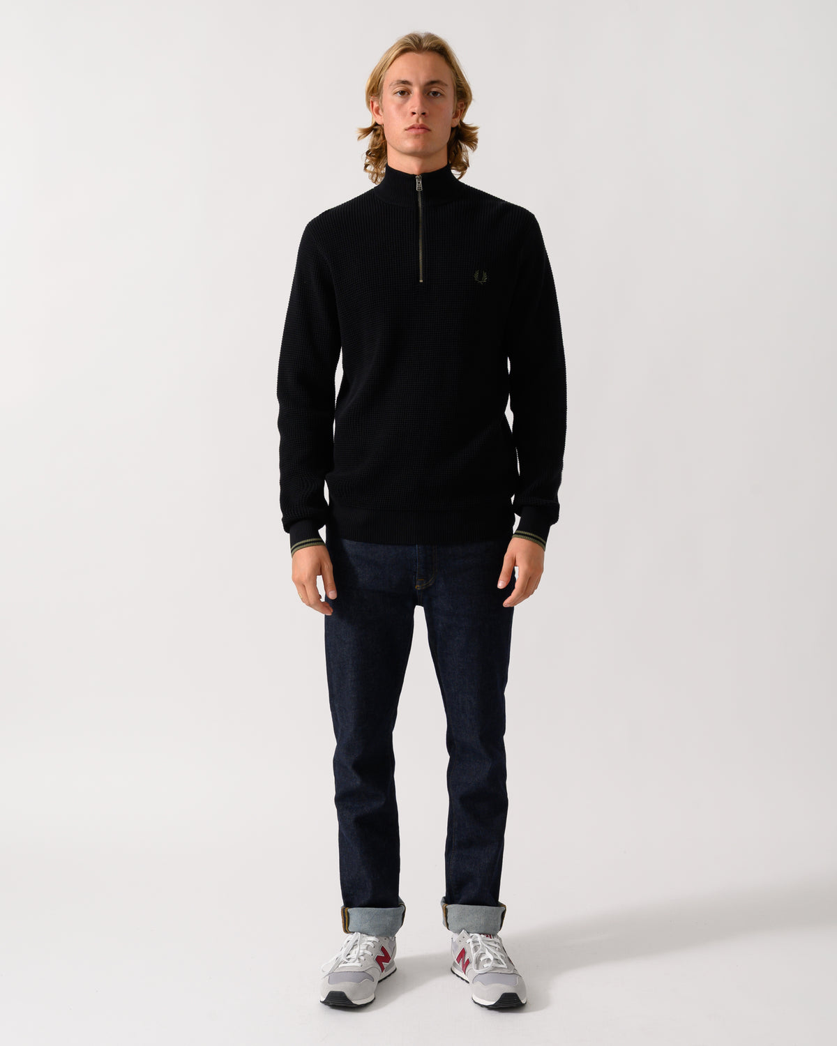 full length of a model wearing a Fred Perry Mens Waffle Stitch Half Zip Jumper in Black 198
