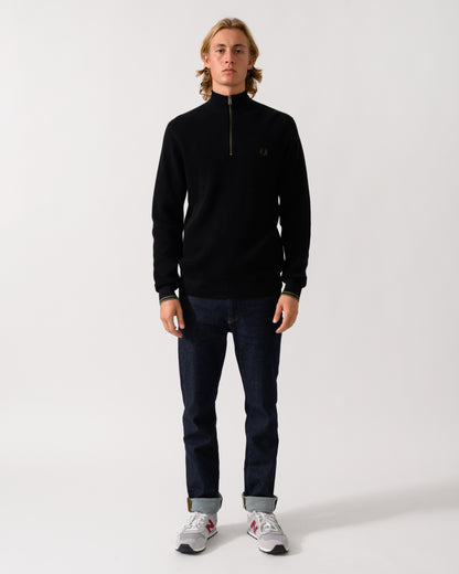 full length of a model wearing a Fred Perry Mens Waffle Stitch Half Zip Jumper in Black 198