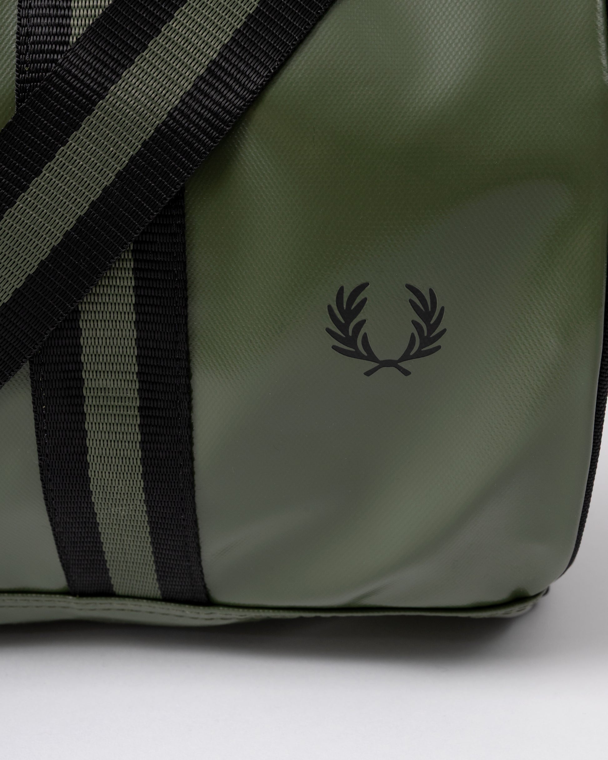 logo detail of a Fred Perry Recycled Polyester Classic Barrel Bag in Laurel Wreath Green and Black Z50