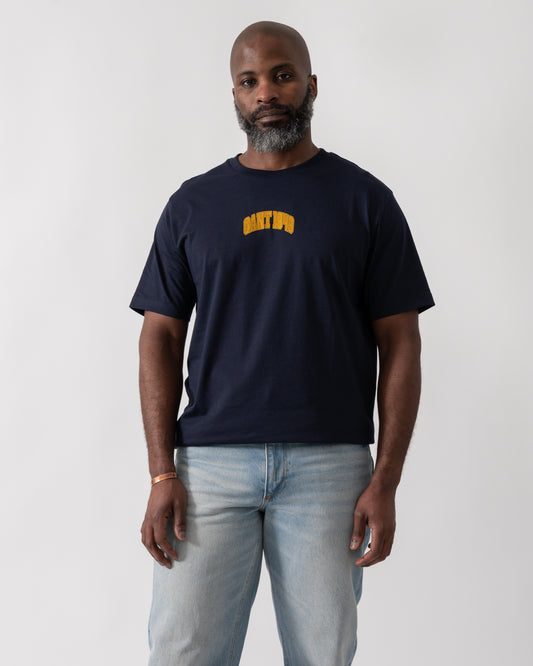 Model wearing a GANT Mens 1949 Graphic Short Sleeve T-Shirt in Evening Blue