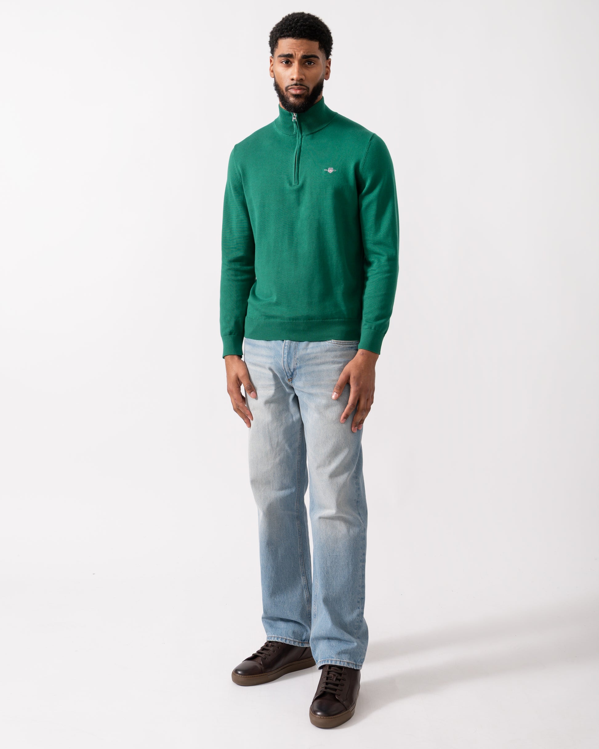 full length shot of a model wearing a GANT Mens Classic Cotton Half Zip Jumper in Deep Forest Green