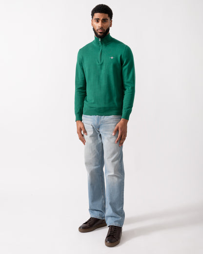 full length shot of a model wearing a GANT Mens Classic Cotton Half Zip Jumper in Deep Forest Green