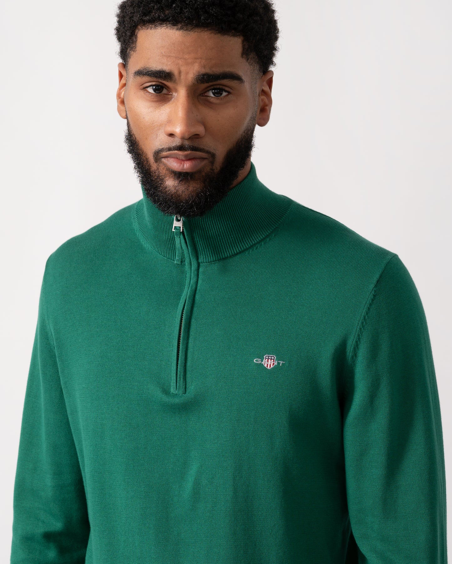 close up shot of a model wearing a GANT Mens Classic Cotton Half Zip Jumper in Deep Forest Green
