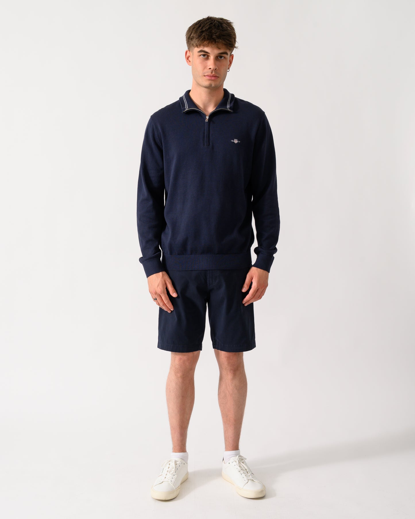 full length shot of a model wearing a GANT Mens Classic Cotton Shield Logo Half Zip Jumper n 433 Evening Blue