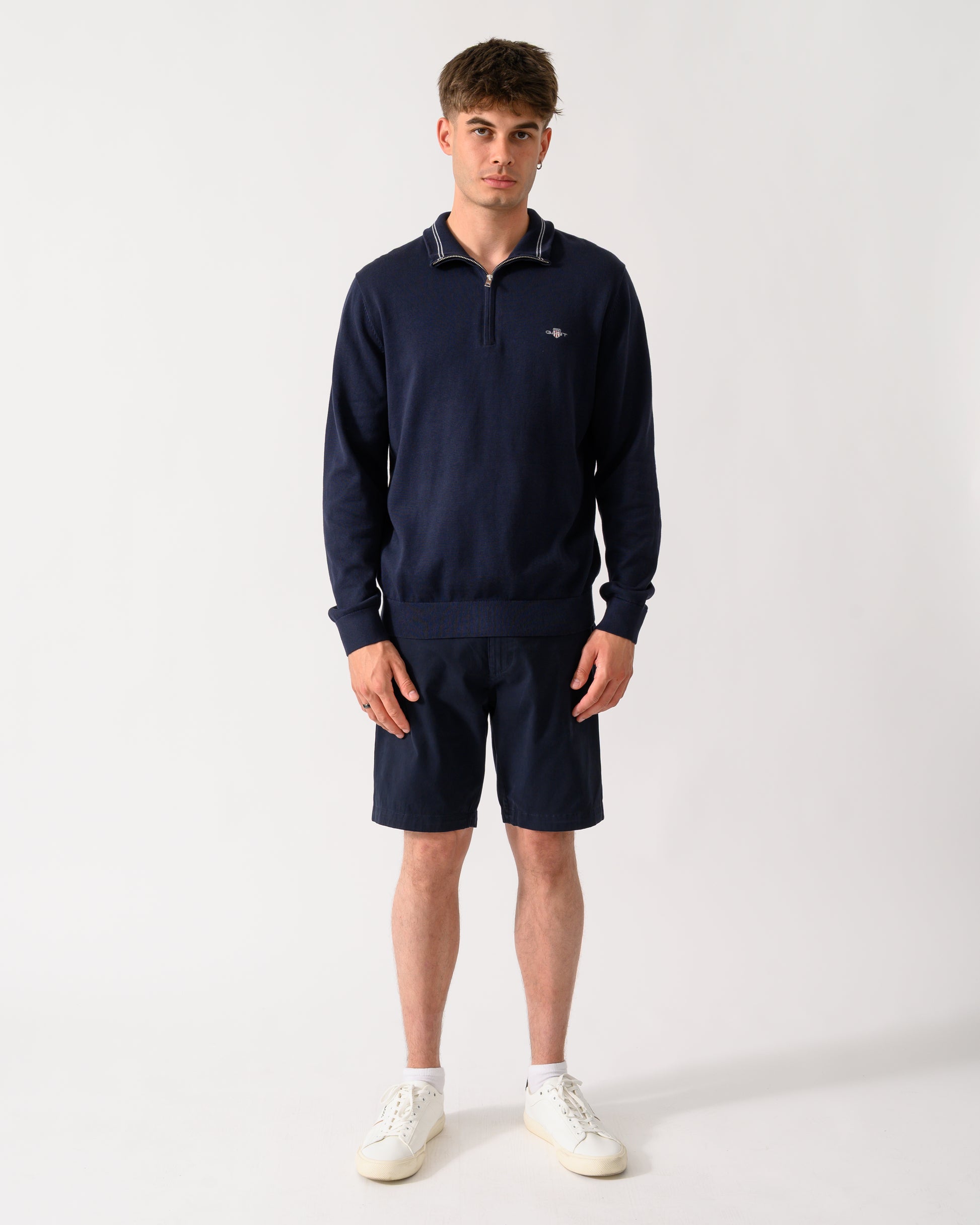 full length shot of a model wearing a GANT Mens Classic Cotton Shield Logo Half Zip Jumper n 433 Evening Blue