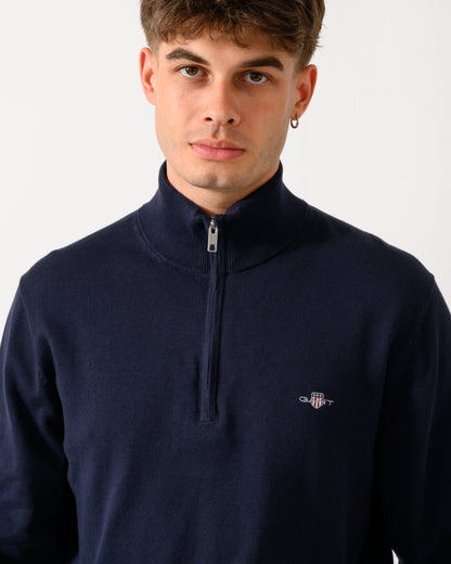 close up shot of a model wearing a GANT Mens Classic Cotton Shield Logo Half Zip Jumper n 433 Evening Blue